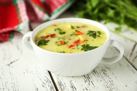 Bowl of soup on white wooden backgroundの写真素材