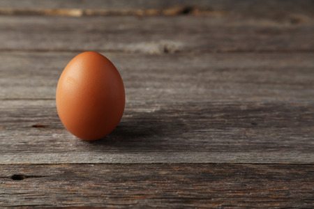 Chicken egg on grey wooden backgroundの写真素材