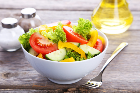 Fresh vegetable salad on grey wooden backgroundの写真素材