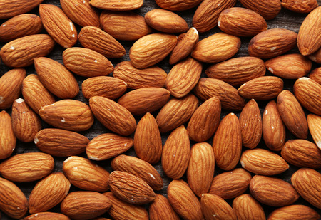 Almonds on brown wooden backgroundの写真素材