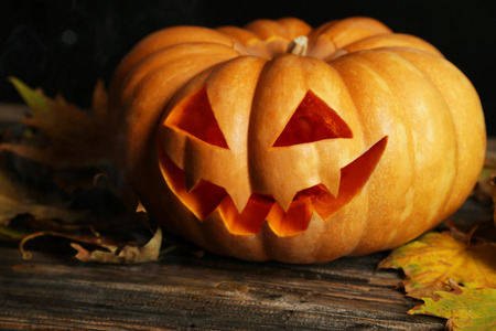 Halloween pumpkin on brown wooden backgroundの写真素材