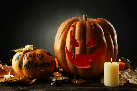 Halloween pumpkin on brown wooden backgroundの写真素材