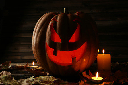 Halloween pumpkin on brown wooden backgroundの写真素材