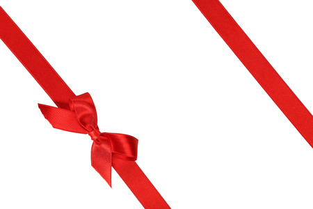 Red ribbon with bow on white backgroundの写真素材