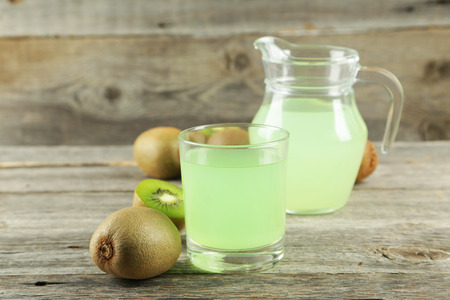 Fresh juice with kiwi on grey wooden backgroundの写真素材