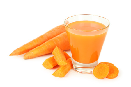 Glass of carrot juice isolated on whiteの写真素材