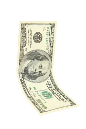 Hundred dollar bill falling on white backgroundの写真素材