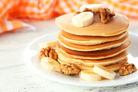 Delicious pancakes with banana on white wooden backgroundの写真素材