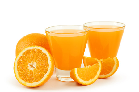 Glass of fresh orange juice isolated on whiteの写真素材