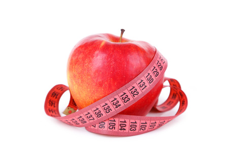 Red apple with measuring tape isolated on whiteの写真素材