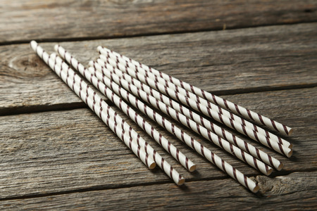 Striped straws for cocktails on grey wooden backgroundの写真素材