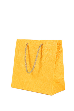 Yellow gift bag isolated on whiteの写真素材