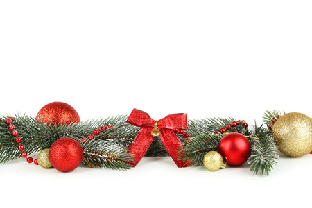 Branch of Christmas tree with balls isolated on whiteの写真素材