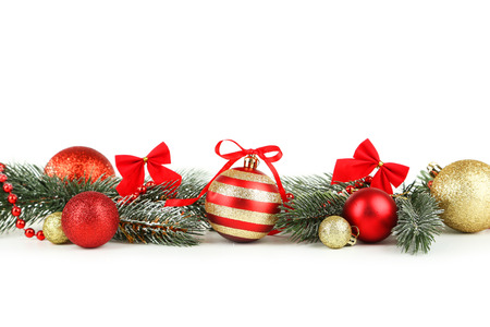 Branch of Christmas tree with balls isolated on whiteの写真素材