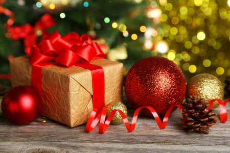 Christmas balls and Christmas gift on grey wooden backgroundの写真素材