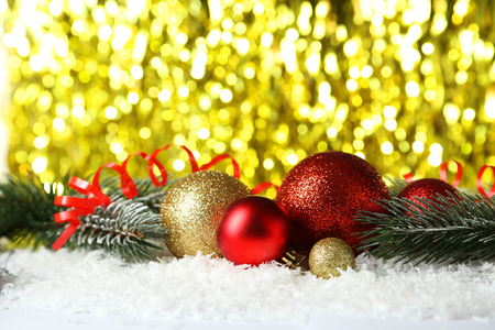 Branch of Christmas tree with balls on snowの写真素材