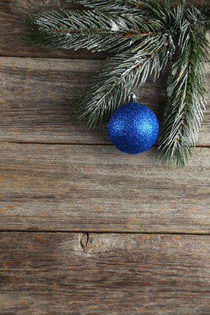 Branch of Christmas tree with balls on grey wooden backgroundの写真素材