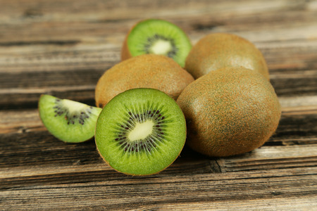Kiwi fruit on brown wooden backgroundの写真素材