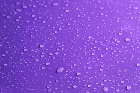 Water drops on purple backgroundの写真素材