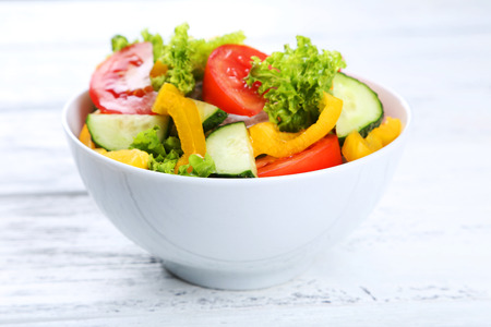 Fresh vegetable salad on white wooden backgroundの写真素材