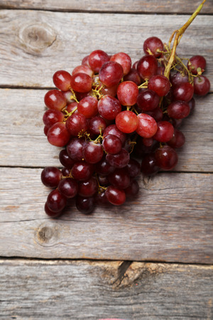 Red grape on grey wooden backgroundの写真素材