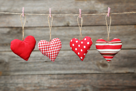 Love hearts hanging on rope on grey wooden backgroundの写真素材