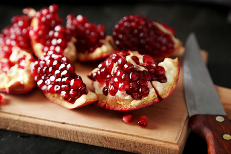 Delicious pomegranate fruit on cutting boardの写真素材