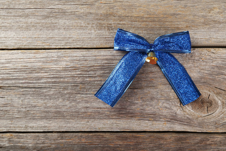 Blue bow on grey wooden backgroundの写真素材