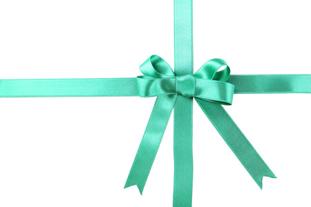 Green ribbon with bow on white backgroundの写真素材