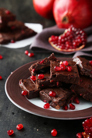 Homemade chocolate fudge with pomegranate on plateの写真素材