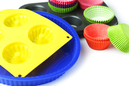 Cupcake cases with silicone shaper on white backgroundの写真素材