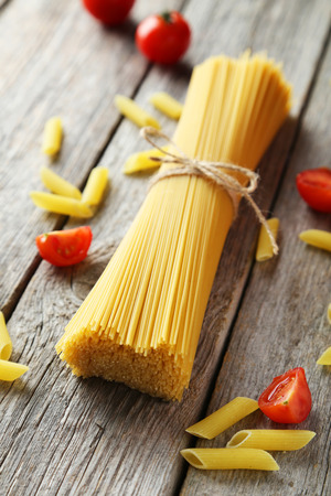 Spaghetti with tomatoes on grey wooden backgroundの写真素材