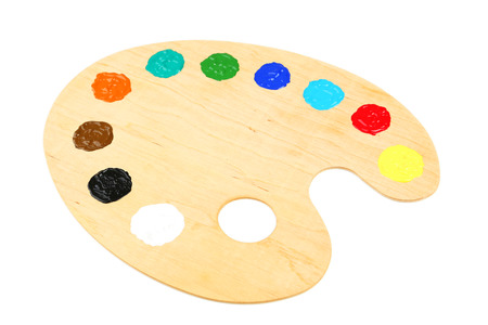 Wooden art palette with paints isolated on whiteの写真素材