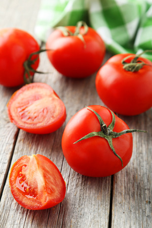 Fresh red tomatos on grey wooden backgroundの写真素材