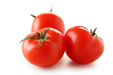 Fresh red tomatos isolated on whiteの写真素材