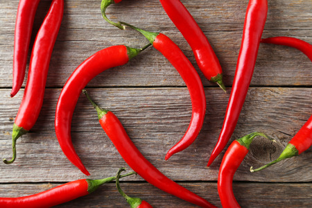 Red chili pepper on grey wooden background