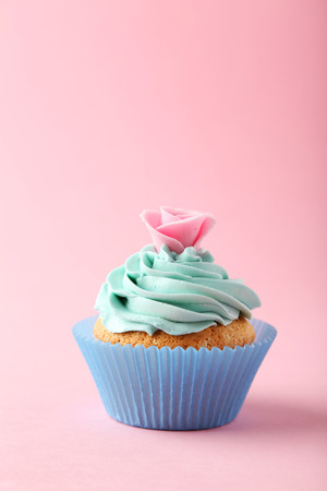 Tasty cupcake on pink backgroundの写真素材