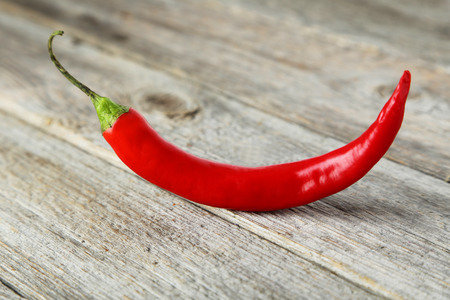 Red chili pepper on grey wooden backgroundの写真素材