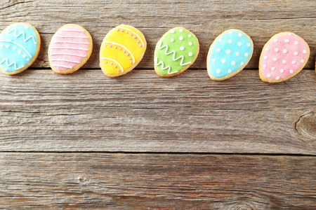 Colorful easter cookies on grey wooden background