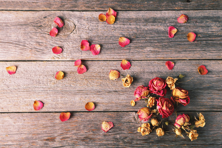 Dried roses on grey wooden background. Toned imageの写真素材