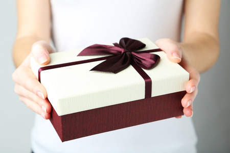 Female hands holding gift boxの写真素材