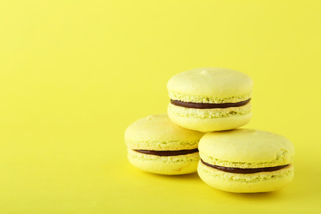 French macarons on yellow backgroundの写真素材