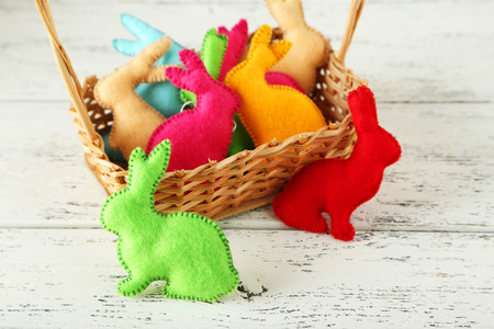 Handmade easter rabbits on white wooden backgroundの写真素材