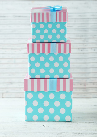 Beautiful gift boxes on white wooden backgroundの写真素材