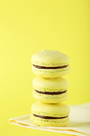 French macarons on yellow backgroundの写真素材