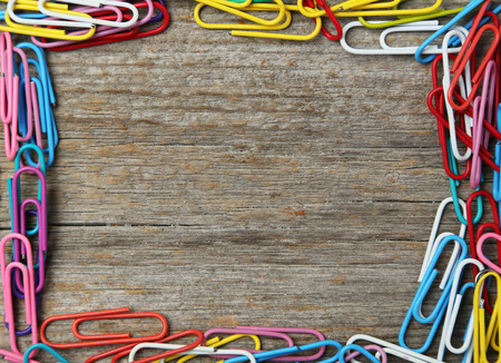 Paper clip on grey wooden backgroundの写真素材