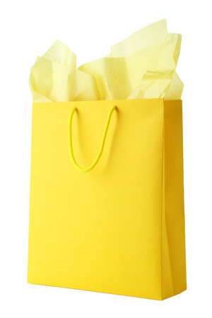 Yellow shopping bag isolated on whiteの写真素材