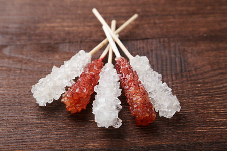 Crystal brown and white sugar candy on brown wooden backgroundの写真素材