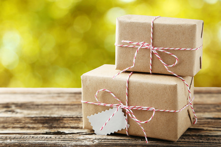 Beautiful gift boxes on brown wooden background