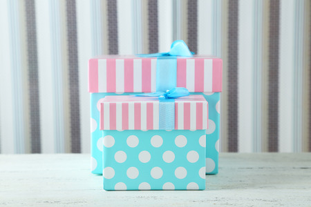 Beautiful gift boxes on white wooden backgroundの写真素材